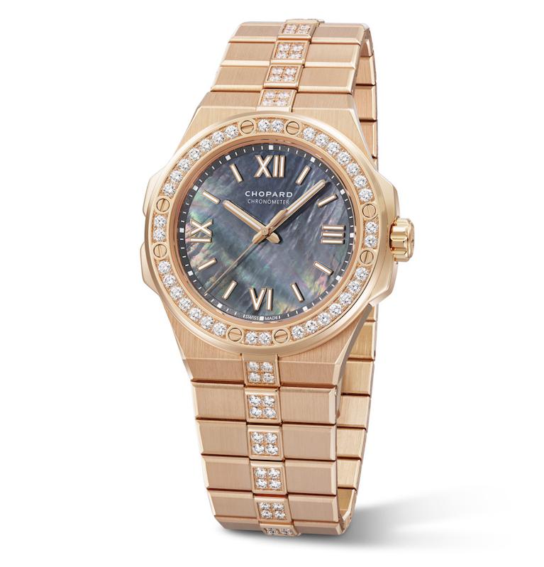 Beautiful gold case watch with embezzled diamonds around the face of the watch 