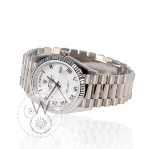 Rolex Day-Date 36 in white gold with fluted bezel, silver dial, and President bracelet.